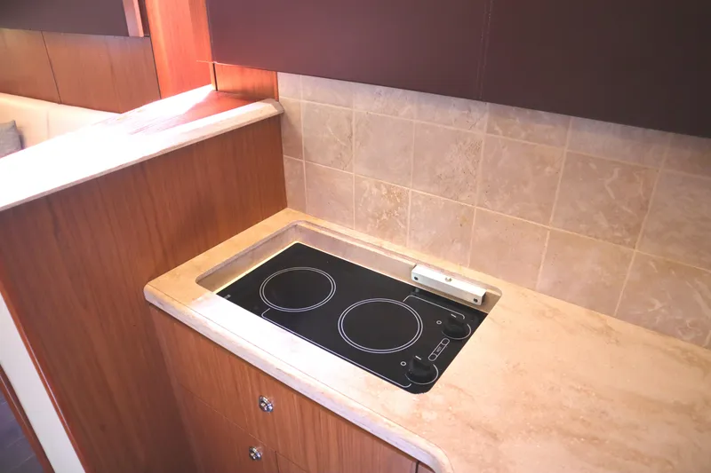 Slide: The Image of Modern kitchen area in 2016 Tiara Yachts 4300 Open with electric stovetop. - 26