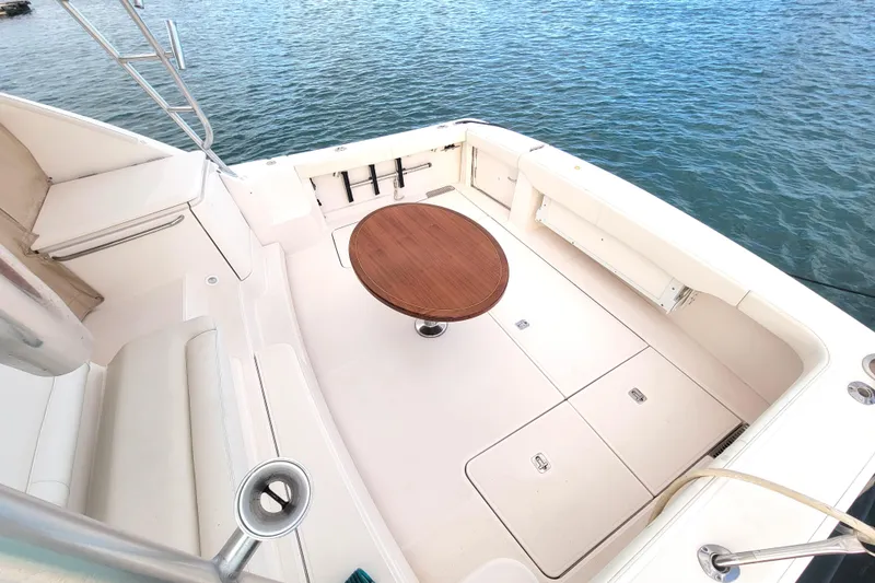 Slide: The Image of 2016 Tiara Yachts 4300 Open deck with round wooden table, overlooking water. - 36