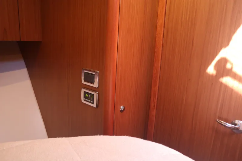 Slide: The Image of Interior of 2016 Tiara Yachts 4300 Open, featuring wooden paneling and control panels. - 5