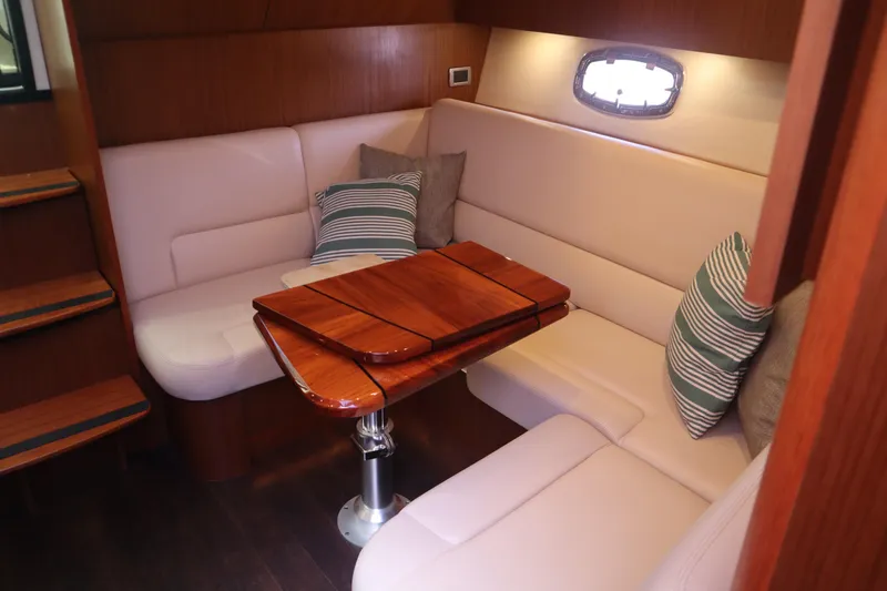 Slide: The Image of Luxurious interior of 2016 Tiara Yachts 4300 Open with plush seating and wooden table. - 6