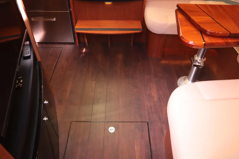 Slide: The Image of Interior of 2016 Tiara Yachts 4300 Open with wood flooring and seating area. - 9