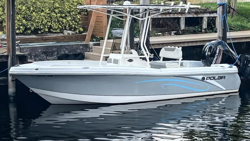 The Image of 2019 Polar 195CC boat docked, featuring sleek design and Mercury outboard motor. - 0
