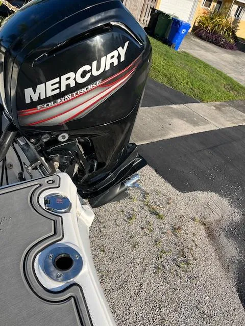 Slide: The Image of Mercury FourStroke engine on a 2019 Polar 195CC boat, parked on gravel. - 12