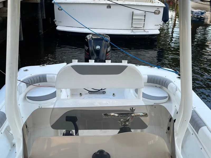 Slide: The Image of 2019 Polar 195CC boat interior with steering wheel and seating, docked in marina. - 5
