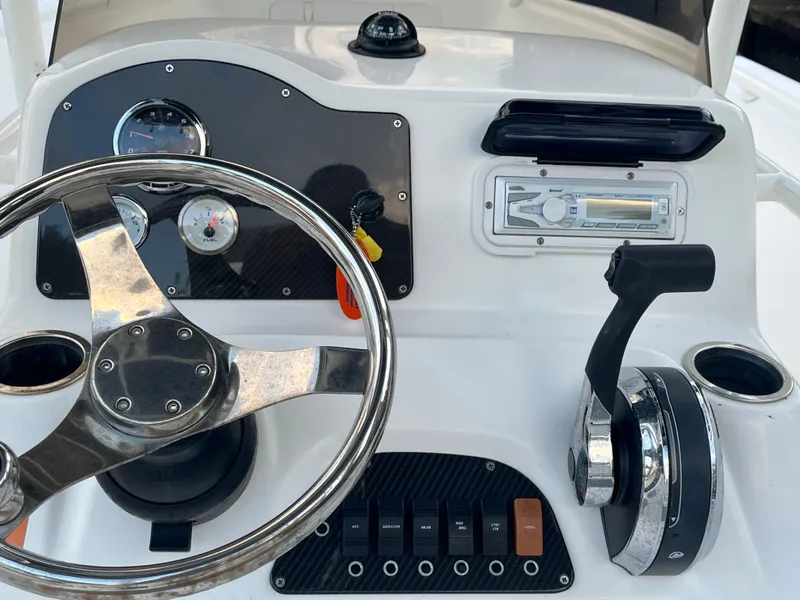 Slide: The Image of Control panel of a 2019 Polar 195CC boat with steering wheel and throttle. - 6