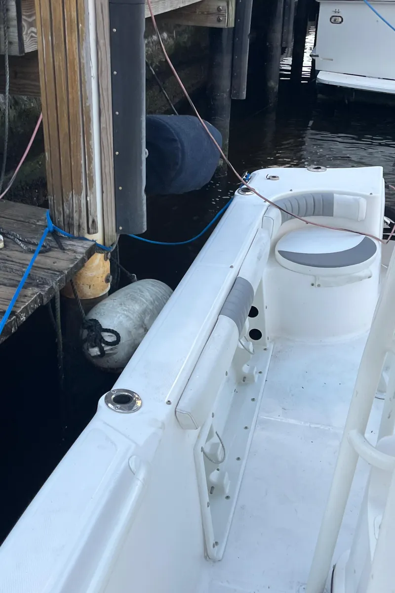 Slide: The Image of 2019 Polar 195CC boat docked, showing interior seating and dock fender. - 8