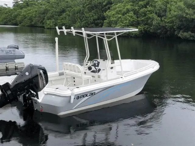 Slide: The Image of 2019 Polar 195CC boat on calm water, featuring a Mercury outboard motor. - 1