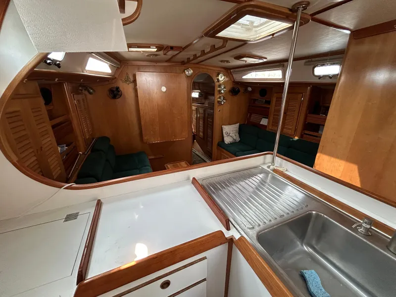 Slide: The Image of Interior of 1994 Freedom 45 Aft Cockpit sailboat with wood finish and cozy seating. - 16