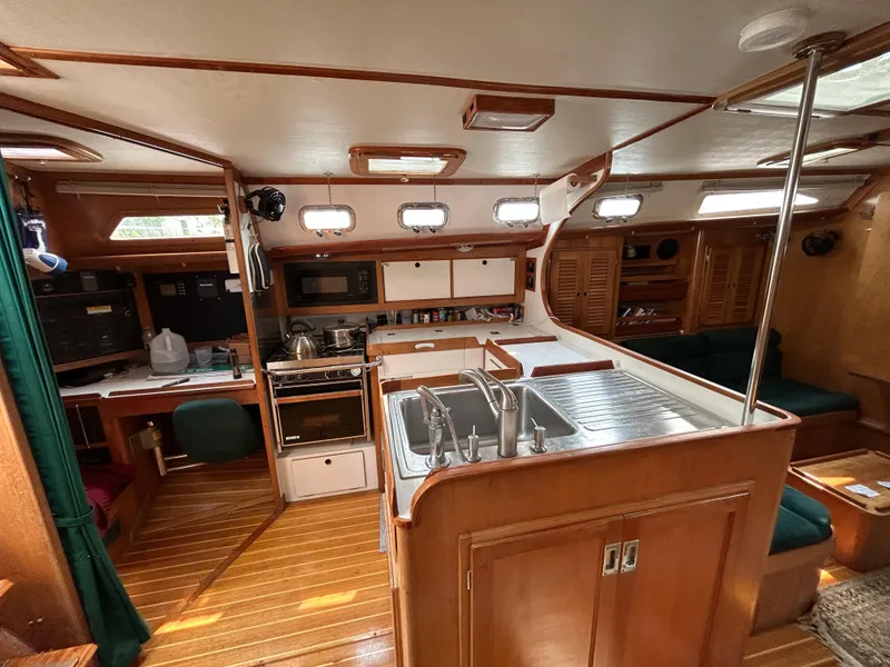 Slide: The Image of Interior of 1994 Freedom 45 Aft Cockpit sailboat with kitchen and seating area. - 17