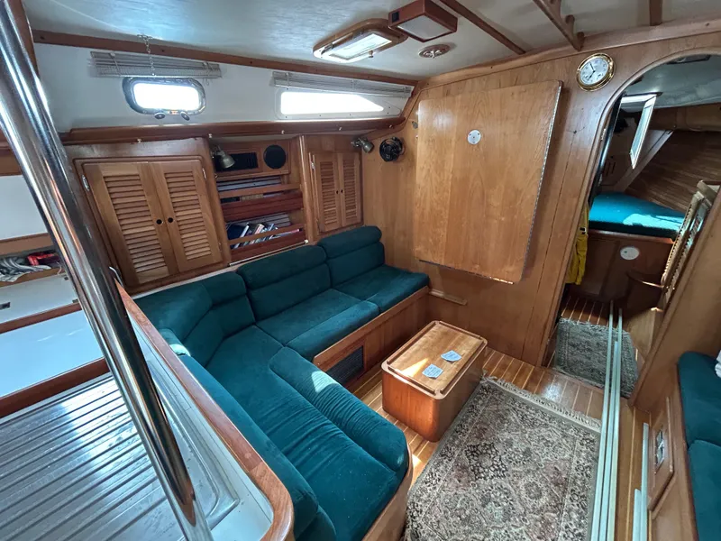 Slide: The Image of Interior of 1994 Freedom 45 Aft Cockpit yacht with wooden finish and blue seating. - 18