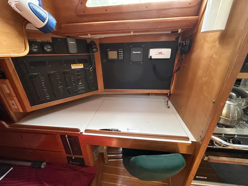 Slide: The Image of 1994 Freedom 45 Aft Cockpit navigation station with control panels and wooden cabinetry. - 20