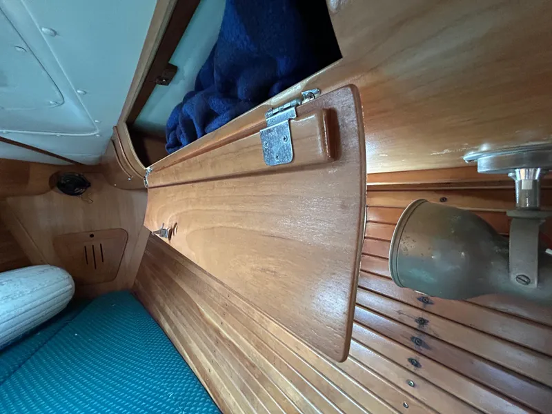 Slide: The Image of Interior of 1994 Freedom 45 Aft Cockpit sailboat with wooden paneling and blue upholstery. - 22
