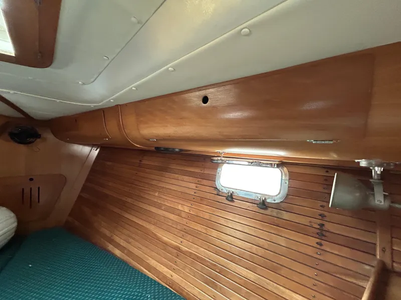 Slide: The Image of Interior of 1994 Freedom 45 Aft Cockpit sailboat with wooden paneling and window. - 23