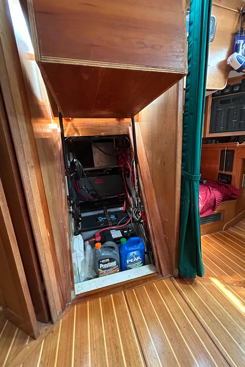 Slide: The Image of Engine compartment of 1994 Freedom 45 Aft Cockpit sailboat with maintenance supplies. - 25