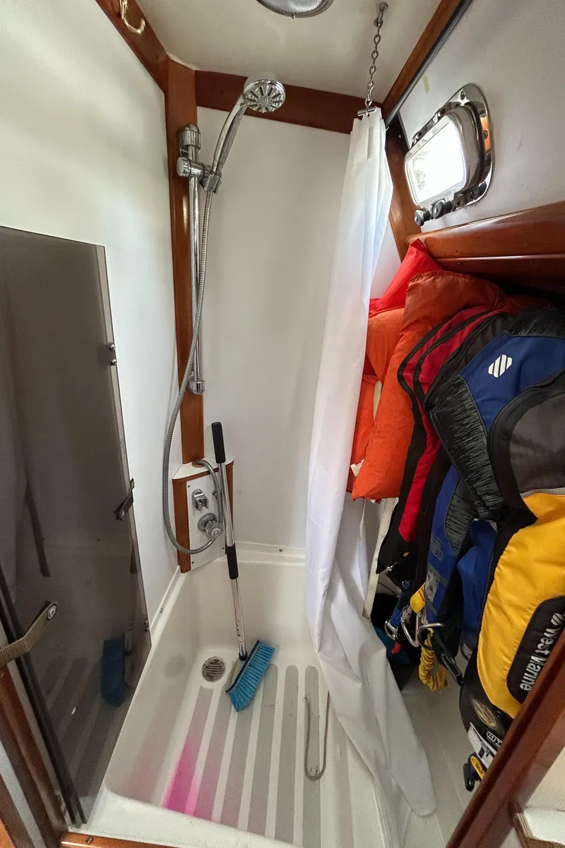 Slide: The Image of Shower area in 1994 Freedom 45 Aft Cockpit sailboat with hanging life jackets. - 27