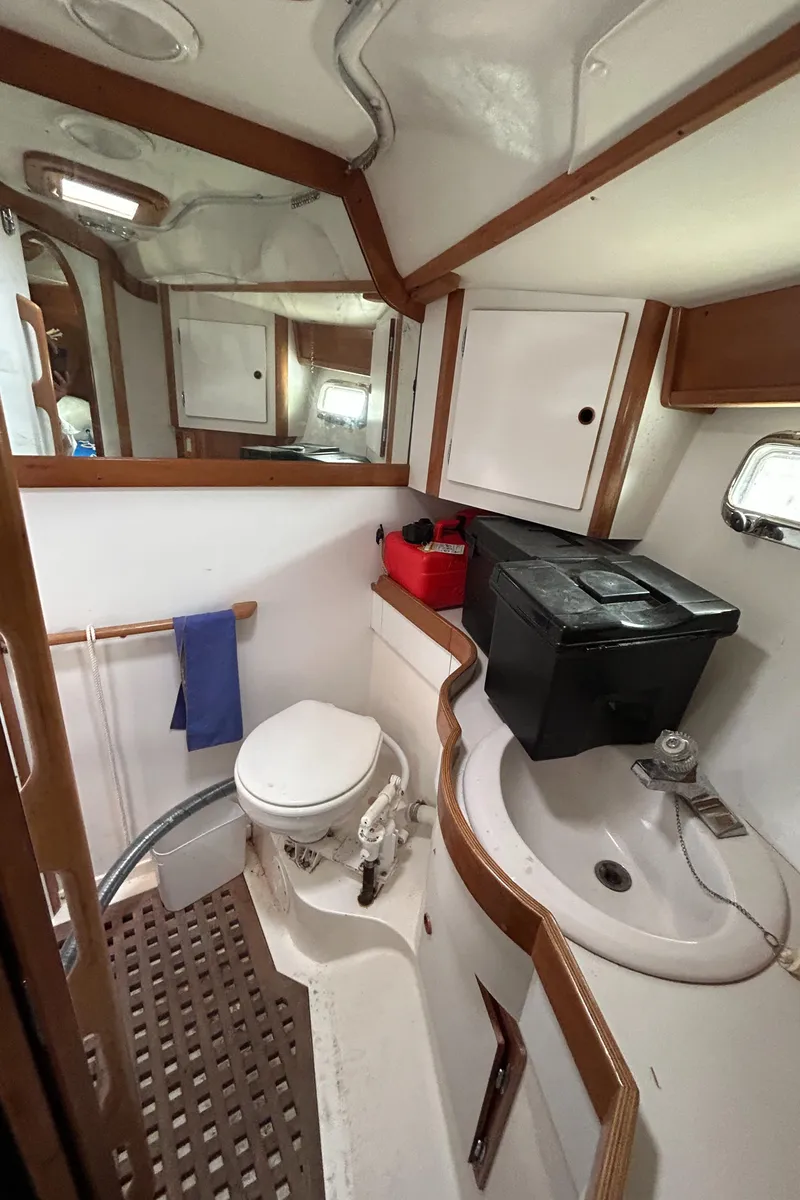 Slide: The Image of 1994 Freedom 45 Aft Cockpit yacht bathroom with sink, toilet, and storage. - 28