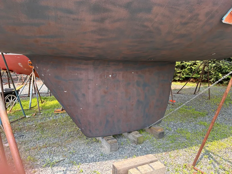 Slide: The Image of 1994 Freedom 45 Aft Cockpit sailboat keel on dry dock, supported by stands. - 29