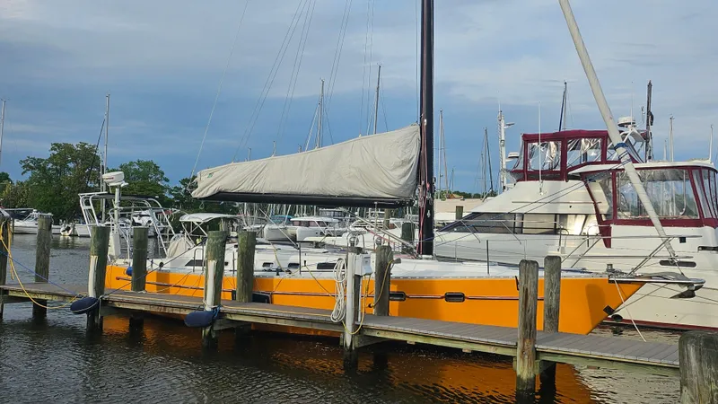Slide: The Image of Orange 1994 Freedom 45 Aft Cockpit sailboat docked at marina. - 3