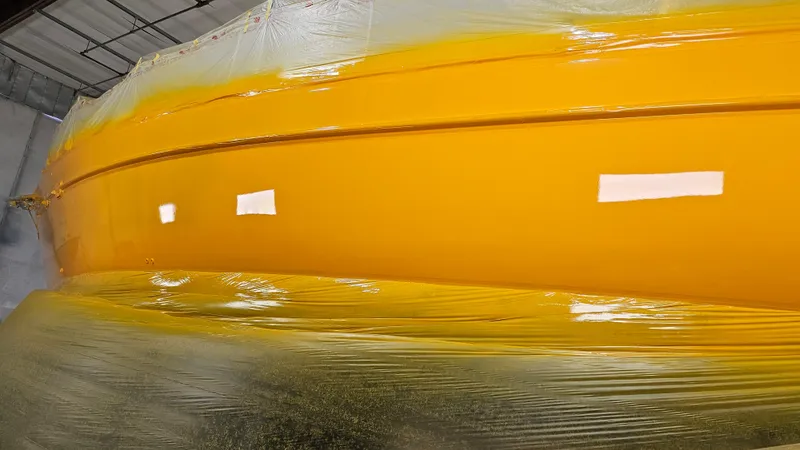Slide: The Image of Yellow Freedom 45 Aft Cockpit boat hull, 1994 model, wrapped in protective plastic. - 8