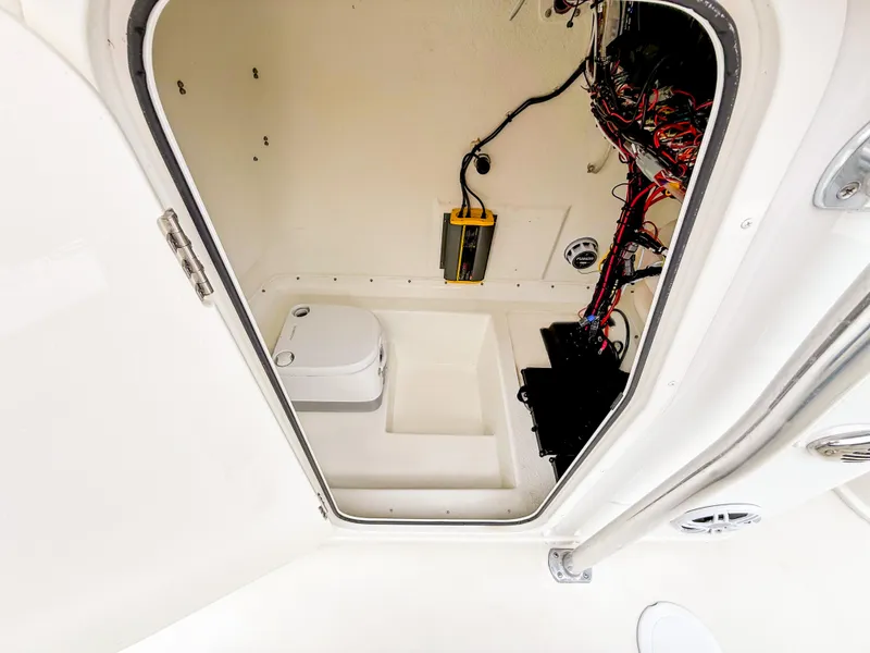 Slide: The Image of 2024 Parker 2501 boat interior with wiring and compact toilet. - 11