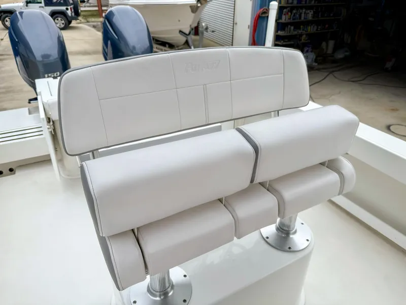 Slide: The Image of 2024 Parker 2501 boat seating with dual engines in a workshop setting. - 12