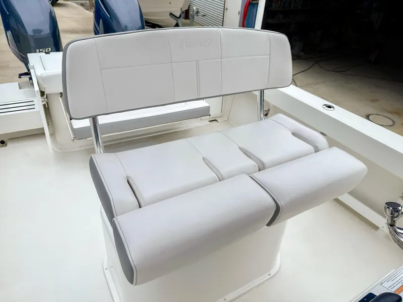 Slide: The Image of 2024 Parker 2501 boat seating with cushioned bench and dual outboard motors. - 13