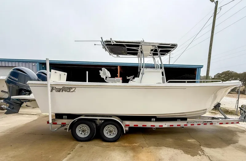 Slide: The Image of 2024 Parker 2501 boat on trailer, side view, with dual outboard motors. - 3