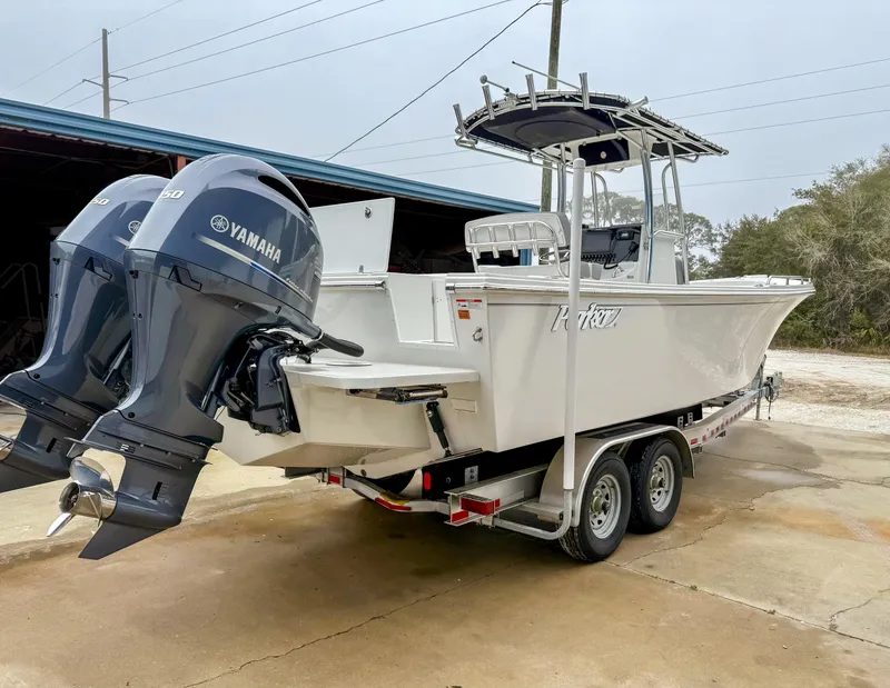 Slide: The Image of 2024 Parker 2501 boat with dual Yamaha engines on a trailer. - 4