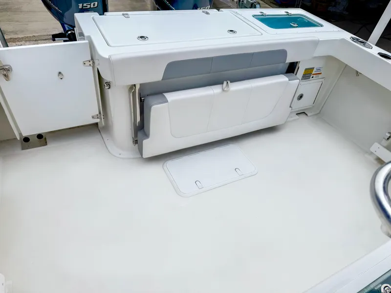 Slide: The Image of 2024 Parker 2501 boat interior with foldable seat and storage compartments. - 6