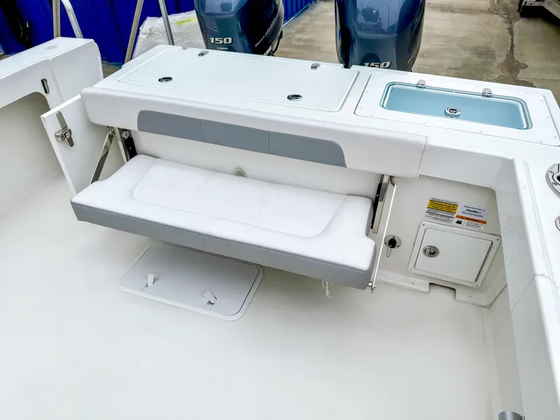 Slide: The Image of 2024 Parker 2501 boat with foldable seat and storage compartments. - 7