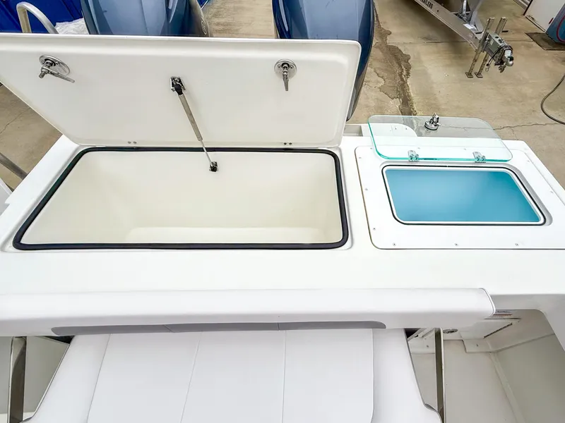 Slide: The Image of 2024 Parker 2501 boat storage compartments with open lids, showcasing spacious design. - 8
