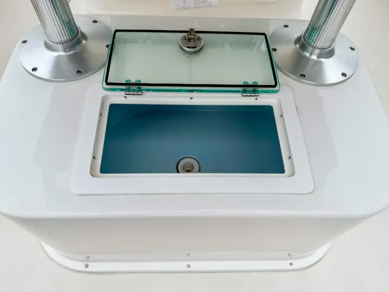 Slide: The Image of 2024 Parker 2501 boat livewell with open glass lid and stainless steel fittings. - 9
