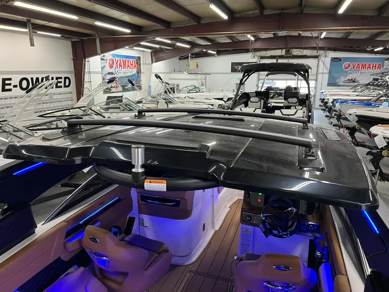 Slide: The Image of 2025 Chaparral 267 SSX boat interior in showroom, featuring sleek design and modern amenities. - 12
