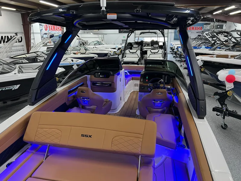 Slide: The Image of 2025 Chaparral 267 SSX boat interior with blue LED lighting and luxurious seating. - 15