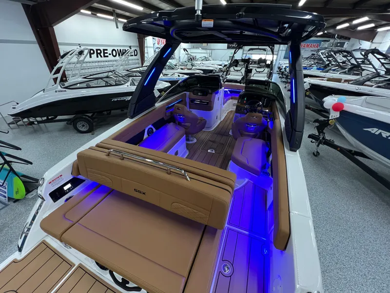 Slide: The Image of 2025 Chaparral 267 SSX boat interior with blue LED lighting in showroom. - 16