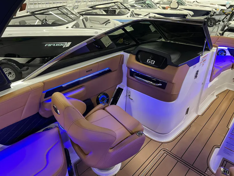 Slide: The Image of 2025 Chaparral 267 SSX boat interior with modern dashboard and luxurious seating. - 18