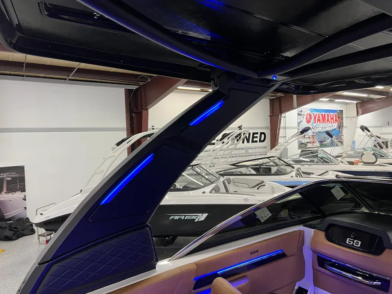 Slide: The Image of 2025 Chaparral 267 SSX boat interior with modern design and blue LED lighting. - 19