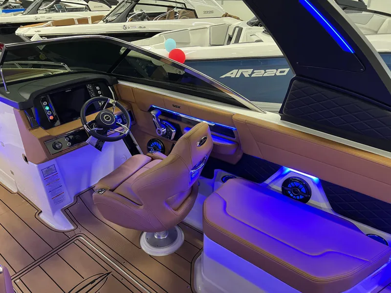 Slide: The Image of Interior of 2025 Chaparral 267 SSX boat with modern dashboard and ambient lighting. - 20