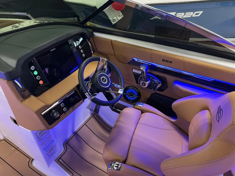 Slide: The Image of Interior of 2025 Chaparral 267 SSX boat with modern dashboard and steering wheel. - 21