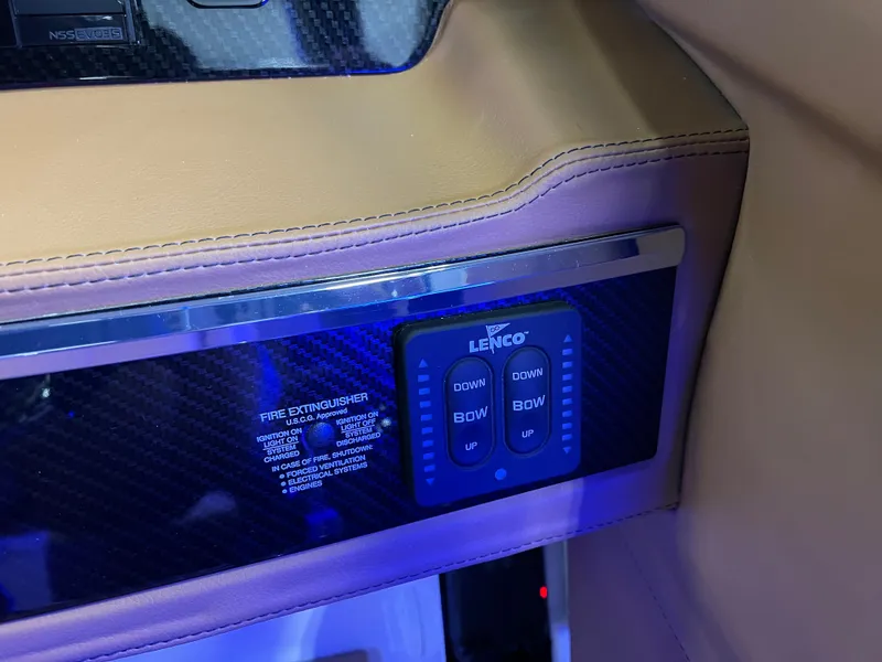 Slide: The Image of Control panel of 2025 Chaparral 267 SSX boat with Lenco trim tab switches. - 26