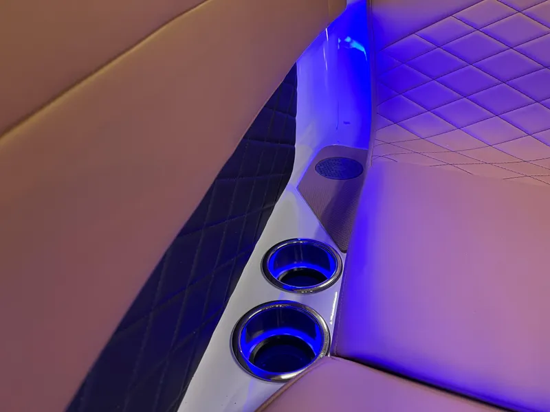 Slide: The Image of 2025 Chaparral 267 SSX interior with blue LED lighting and cup holders. - 30