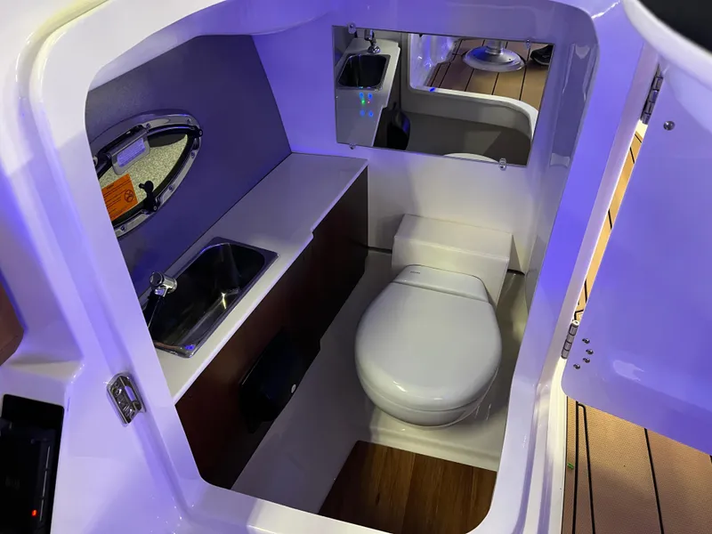 Slide: The Image of 2025 Chaparral 267 SSX boat interior bathroom with sink and toilet. - 34
