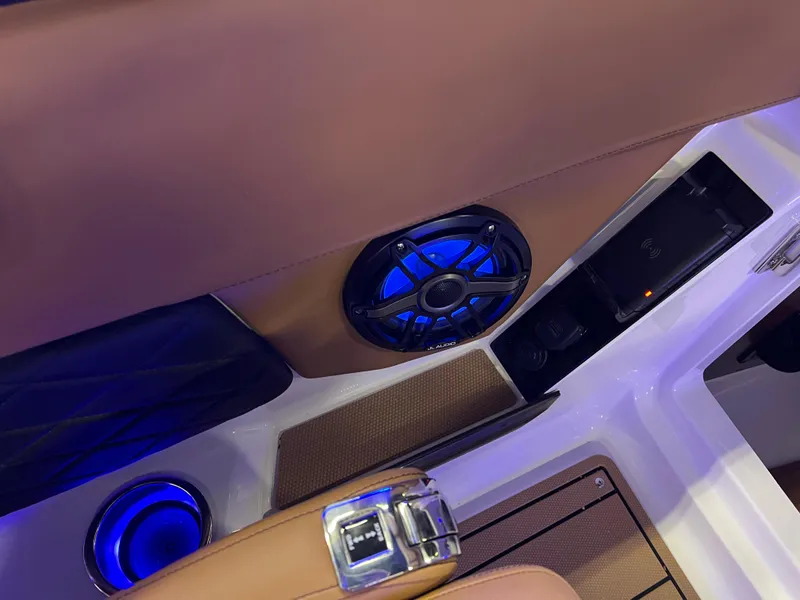 Slide: The Image of Interior of 2025 Chaparral 267 SSX boat with blue LED lighting and speaker system. - 35