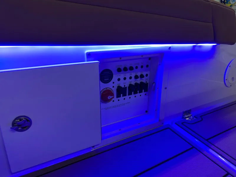 Slide: The Image of Control panel of 2025 Chaparral 267 SSX boat with blue LED lighting. - 37