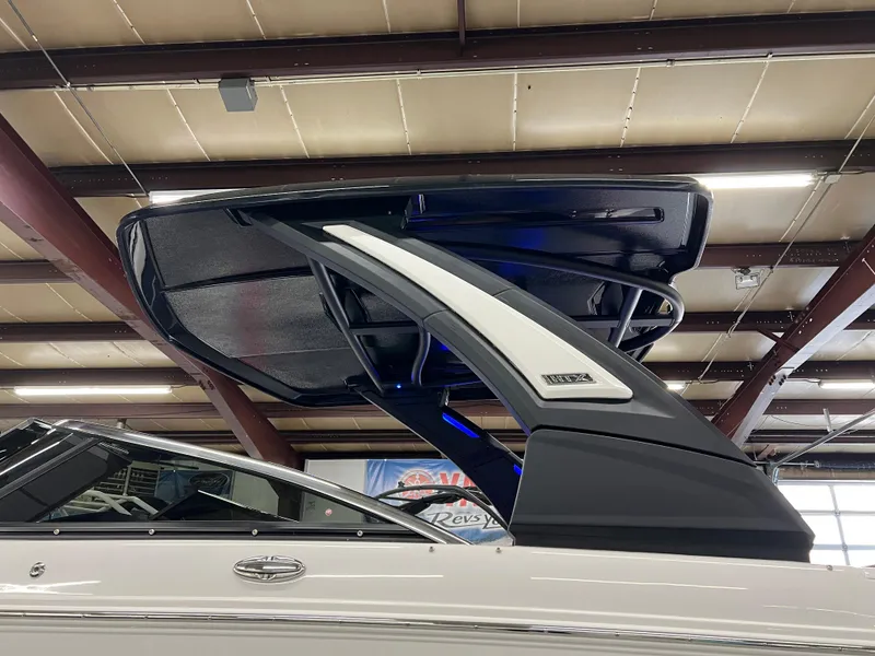 Slide: The Image of 2025 Chaparral 267 SSX boat with sleek design and modern features in showroom. - 4