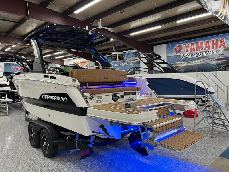 Slide: The Image of 2025 Chaparral 267 SSX boat displayed indoors with blue lighting and Yamaha signage. - 5