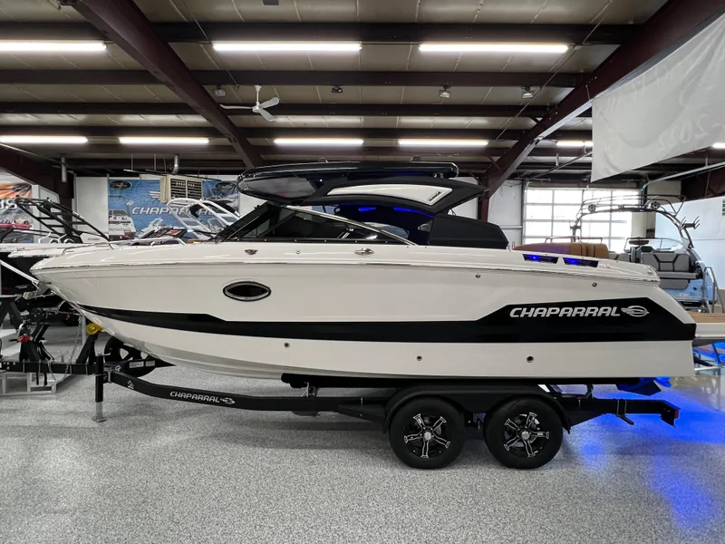 Slide: The Image of 2025 Chaparral 267 SSX boat displayed indoors on a trailer. - 7