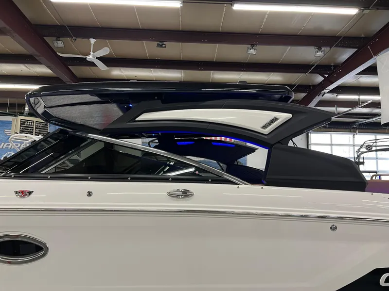 Slide: The Image of 2025 Chaparral 267 SSX boat in showroom, showcasing sleek design and modern features. - 8