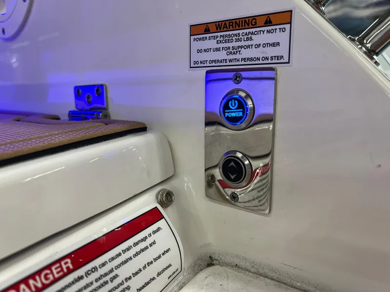 Slide: The Image of Control panel on 2025 Chaparral 267 SSX boat with warning labels and power button. - 9