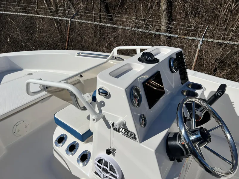Slide: The Image of 2025 Robalo R160 Center Console boat interior with steering wheel and control panel. - 12